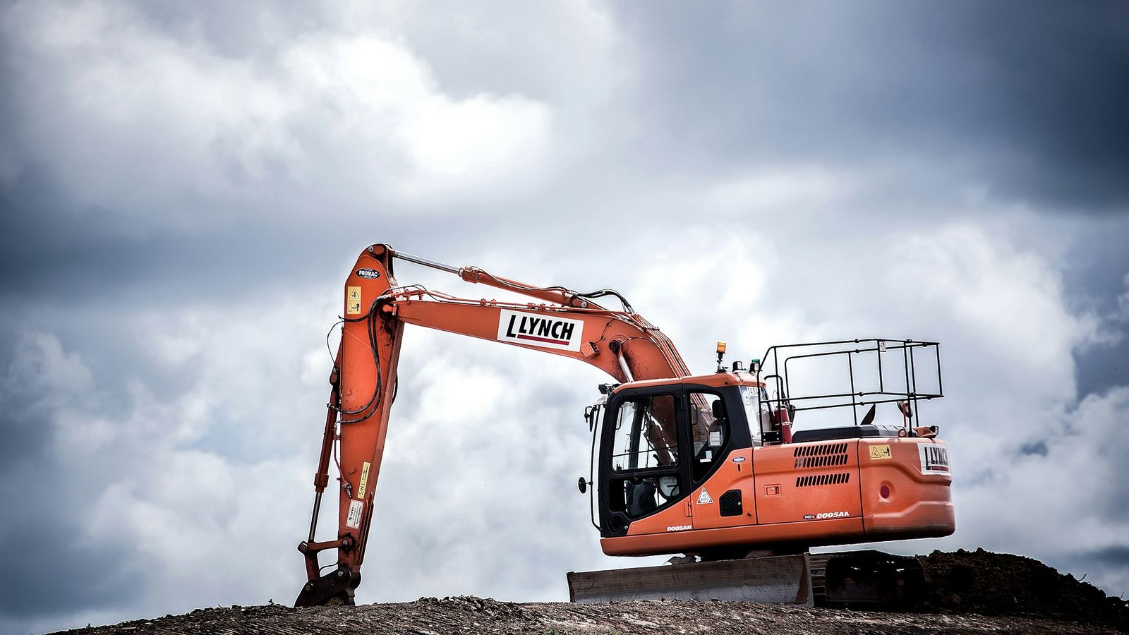An excavator digging at a construction site.