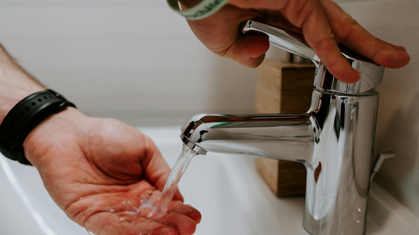 A faucet with water washing hands.