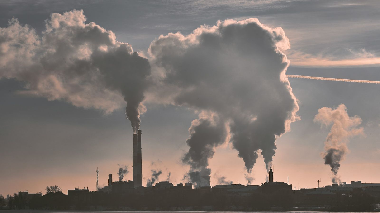 Factories and smokestacks emitting pollution into the air. 